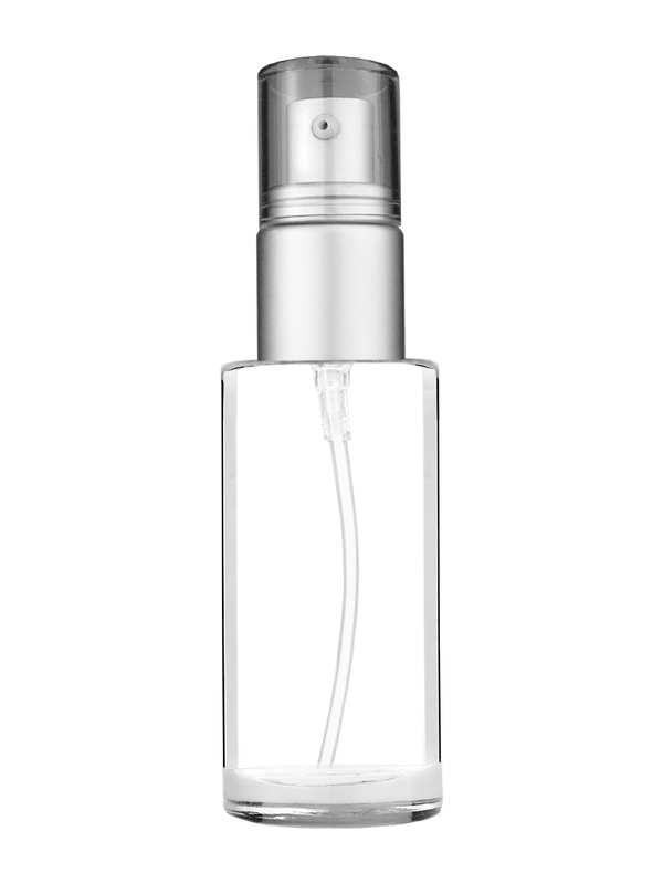 Cylinder design 25 ml clear glass bottle  with with a matte silver collar treatment pump and clear overcap.